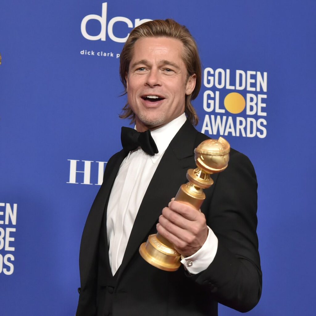 Brad Pitt holding an award