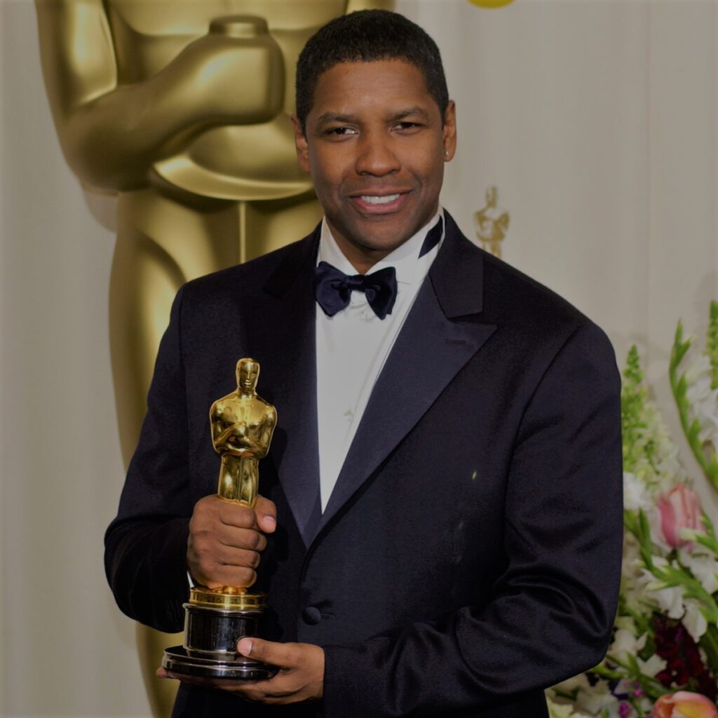 Denzel Washington holding an award