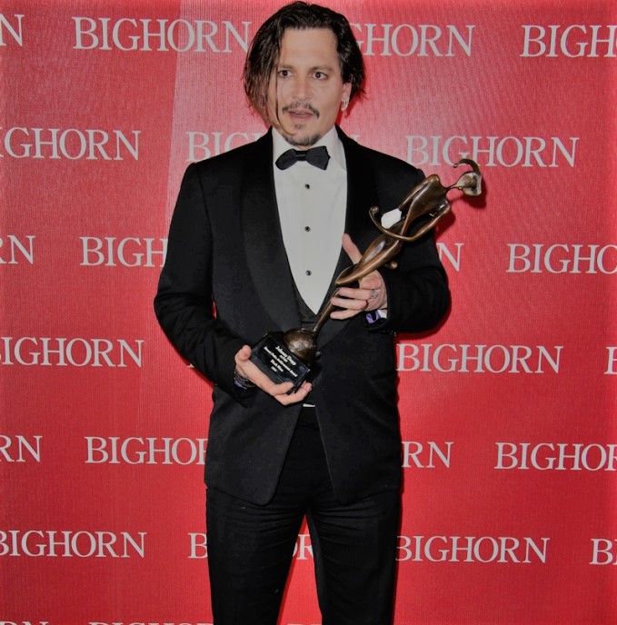 Johnny Depp holding an award
